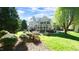 Spacious backyard featuring a patio, manicured lawn, and mature trees at 325 Hogans Valley Way, Cary, NC 27513