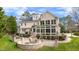Expansive backyard showcasing a patio, sunroom, and well-maintained lawn at 325 Hogans Valley Way, Cary, NC 27513