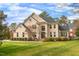Beautiful two-story brick home with a well-manicured lawn and landscaping at 325 Hogans Valley Way, Cary, NC 27513