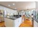 Spacious kitchen featuring white cabinets, a center island, and hardwood floors at 325 Hogans Valley Way, Cary, NC 27513