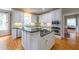 Bright kitchen featuring white cabinetry, dark countertops, and stainless steel appliances at 325 Hogans Valley Way, Cary, NC 27513