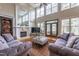 Spacious living room with fireplace, large mirror, plush seating, and many windows at 325 Hogans Valley Way, Cary, NC 27513