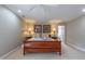 Comfortable main bedroom featuring a wood bed frame, neutral colors, and access to an ensuite bathroom at 325 Hogans Valley Way, Cary, NC 27513