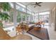 Relaxing sunroom with wicker furniture, tile floors, and lots of natural light at 325 Hogans Valley Way, Cary, NC 27513