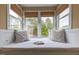 Cozy window seat featuring plush pillows, bright natural light, and views of the surrounding greenery at 325 Hogans Valley Way, Cary, NC 27513