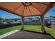 Backyard with patio, gazebo, green grass, and privacy fence, offering a relaxing outdoor space at 33 White Ash Dr, Clayton, NC 27527