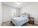 Cozy bedroom featuring an iron bed frame, carpet floors, and a bright window at 33 White Ash Dr, Clayton, NC 27527