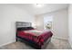 Bright bedroom featuring a bed, carpet, and window at 33 White Ash Dr, Clayton, NC 27527