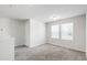 Bright bonus room featuring carpet, two windows, and neutral paint at 33 White Ash Dr, Clayton, NC 27527