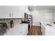 Stylish kitchen with white cabinets, quartz countertops, stainless steel appliances, and modern backsplash at 33 White Ash Dr, Clayton, NC 27527