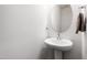 Powder room with pedestal sink and round mirror. Neutral walls at 33 White Ash Dr, Clayton, NC 27527
