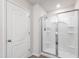 Shower featuring clear glass doors and a chrome showerhead at 33 White Ash Dr, Clayton, NC 27527