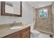 Well-lit bathroom with a vanity and a tiled stand up shower at 3312 Apache Dr, Raleigh, NC 27609