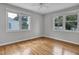 Bedroom boasts hardwood flooring, a ceiling fan, and large windows that provide ample natural light at 3312 Apache Dr, Raleigh, NC 27609