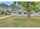 Charming home featuring a well-maintained front yard and a convenient carport at 3312 Apache Dr, Raleigh, NC 27609