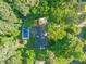 Aerial view of home showcasing a private pool, mature trees, and lush green surroundings at 3420 Sheridan Dr, Durham, NC 27707