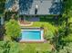 Expansive aerial view showing in-ground swimming pool, a backyard fire pit, patio, and lush landscaping at 3420 Sheridan Dr, Durham, NC 27707