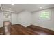 Finished basement featuring hardwood floors, a window, and closet space, ideal for storage and organization at 3420 Sheridan Dr, Durham, NC 27707