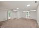 Spacious finished basement with carpet flooring, white walls, recessed lighting, and double doors to the backyard at 3420 Sheridan Dr, Durham, NC 27707