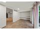 Basement bonus room featuring built-in shelves, tiled floor, and open doors to the rest of the basement at 3420 Sheridan Dr, Durham, NC 27707