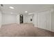 Finished basement with carpet flooring, white walls, closet and glimpses of the fireplace room at 3420 Sheridan Dr, Durham, NC 27707