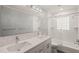 Modern bathroom featuring a double sink vanity, glass shower, and tiled walls at 3420 Sheridan Dr, Durham, NC 27707