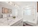 Bathroom featuring a double sink vanity, updated fixtures, and a subway tile shower and tub at 3420 Sheridan Dr, Durham, NC 27707