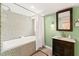 Modern bathroom boasts a tiled shower-tub combo and vanity with ample storage at 3420 Sheridan Dr, Durham, NC 27707