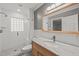 Stylish bathroom with a glass-enclosed shower, wood vanity, and modern fixtures at 3420 Sheridan Dr, Durham, NC 27707