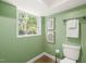 Comfortable bathroom featuring a pristine toilet, a window, and fresh, bright paint at 3420 Sheridan Dr, Durham, NC 27707