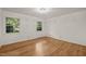 A spacious bedroom offers a versatile space with hardwood floors and neutral walls at 3420 Sheridan Dr, Durham, NC 27707