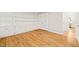 Bedroom with hardwood floors, built-in shelving, and white doors and trim at 3420 Sheridan Dr, Durham, NC 27707