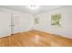 Bedroom with hardwood floors, two windows, and a closet for storage at 3420 Sheridan Dr, Durham, NC 27707