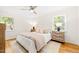 Bright bedroom with neutral decor, a ceiling fan, and windows providing natural light at 3420 Sheridan Dr, Durham, NC 27707