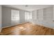 Versatile room featuring hardwood floors, built-in shelving, and natural light at 3420 Sheridan Dr, Durham, NC 27707