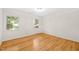 Bedroom featuring hardwood floors and two windows offering natural light at 3420 Sheridan Dr, Durham, NC 27707