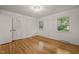 Charming bedroom with natural light, complemented by hardwood floors and closet at 3420 Sheridan Dr, Durham, NC 27707