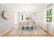 Airy dining room with a modern chandelier and large windows overlooking a lovely landscape at 3420 Sheridan Dr, Durham, NC 27707