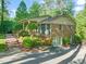 Brick house featuring mature landscaping, a side entrance, and a driveway leading to the back of the property at 3420 Sheridan Dr, Durham, NC 27707