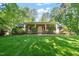 Charming brick home featuring a manicured lawn and lush landscaping at 3420 Sheridan Dr, Durham, NC 27707