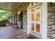 A lovely front porch featuring brick flooring and quaint seating at 3420 Sheridan Dr, Durham, NC 27707