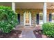 Charming brick porch with elegant columns, shutters, and a decorative white front door at 3420 Sheridan Dr, Durham, NC 27707
