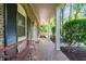 Long front porch with a brick floor and comfortable outdoor seating at 3420 Sheridan Dr, Durham, NC 27707