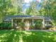 Charming brick home with a well-manicured front yard, lush green lawn, and welcoming front porch at 3420 Sheridan Dr, Durham, NC 27707