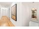 Hallway featuring hardwood floors, contemporary art, and recessed lighting at 3420 Sheridan Dr, Durham, NC 27707