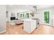 Open kitchen with island, stainless steel appliances, and seamless flow to the Gathering room at 3420 Sheridan Dr, Durham, NC 27707
