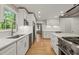 Open kitchen layout with stainless steel appliances, bright countertops, and hardwood floors at 3420 Sheridan Dr, Durham, NC 27707