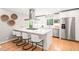 Bright kitchen featuring a gas cooktop island with modern stainless-steel appliances and white cabinetry at 3420 Sheridan Dr, Durham, NC 27707