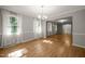 Bright and spacious living room features hardwood floors, neutral walls, ample windows, and views into other living areas at 3420 Sheridan Dr, Durham, NC 27707