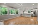 Spacious living room with hardwood floors, natural light and a view into the kitchen at 3420 Sheridan Dr, Durham, NC 27707